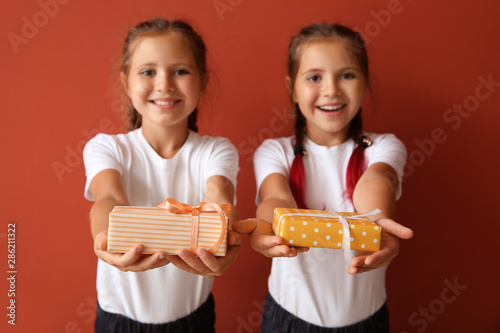 Cute twin girls with gift b...