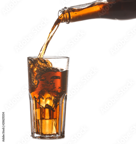 Pouring of cold cola into glass on white background