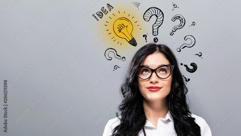Idea light bulbs with question marks with young businesswoman in a thoughtful face - obrazy, fototapety, plakaty 