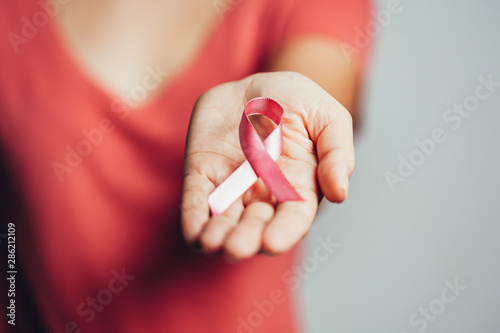 Healthcare and medicine concept - woman holding pink breast cancer awareness ribbon photo