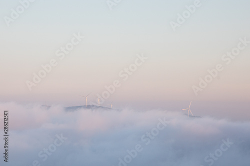 Landscape of clouds and hill with windmills and open sky