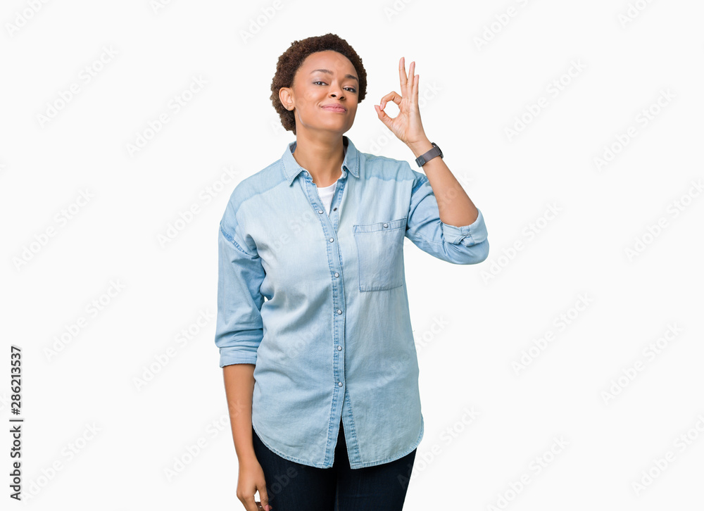 Young beautiful african american woman over isolated background smiling positive doing ok sign with hand and fingers. Successful expression. Young beautiful african american woman over isolated background smiling positive doing ok sign with hand and fingers. Successful expression.