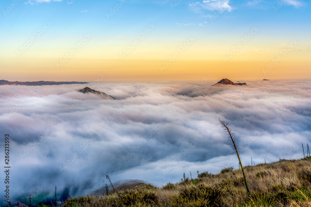 Sunrise with Mountain Peaks Above the Sea of Clouds Sunrise with Mountain Peaks Above the Sea of Clouds