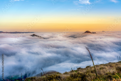 Sunrise with Mountain Peaks Above the Sea of Clouds