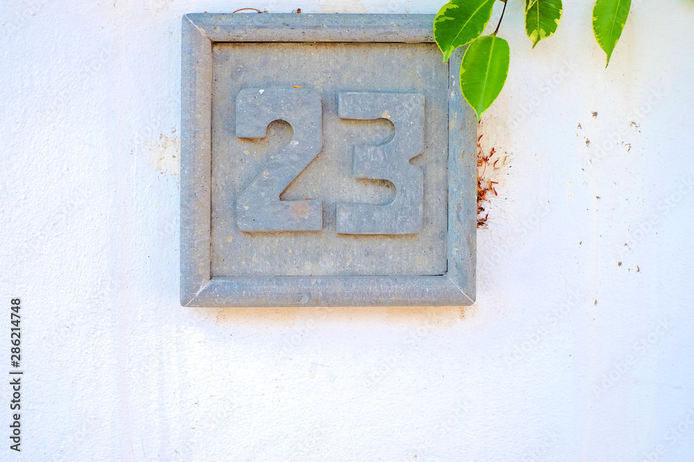 23, number twenty-three, decorative stone plate on white surface. 23, number twenty-three, decorative stone plate on white surface.