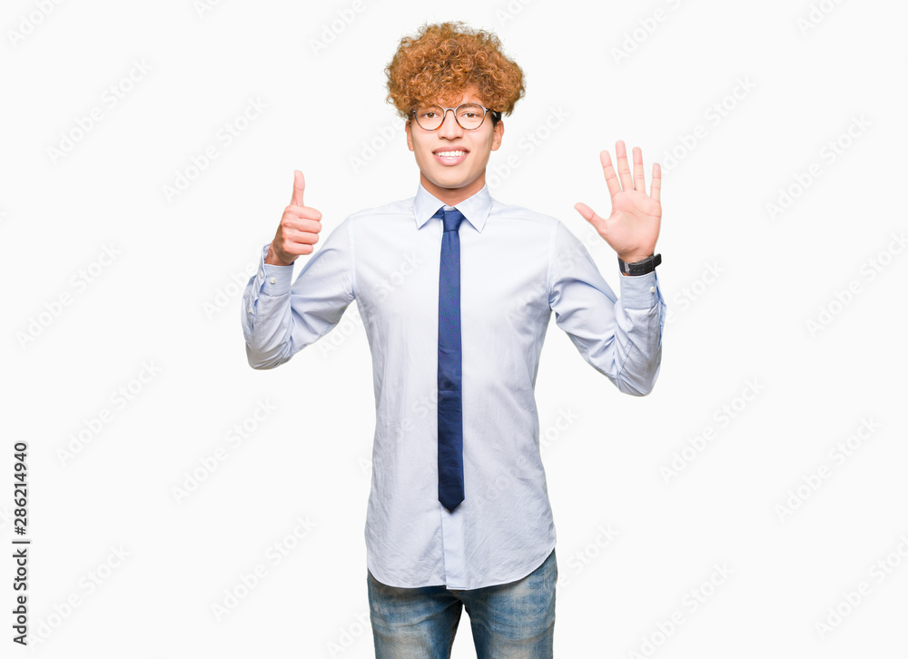 Young handsome business man with afro wearing glasses showing and pointing up with fingers number six while smiling confident and happy.