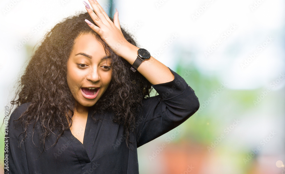 Young beautiful girl with curly hair wearing elegant dress surprised with hand on head for mistake, remember error. Forgot, bad memory concept. Young beautiful girl with curly hair wearing elegant dress surprised with hand on head for mistake, remember error. Forgot, bad memory concept.