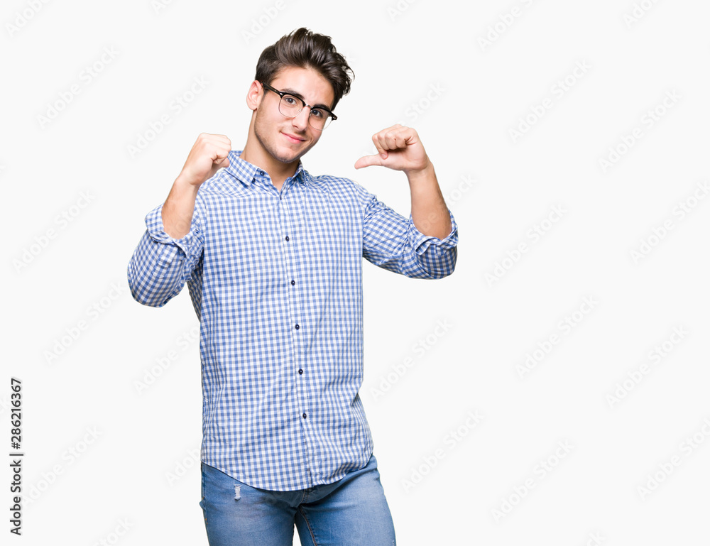 Young handsome man wearing glasses over isolated background looking confident with smile on face, pointing oneself with fingers proud and happy.