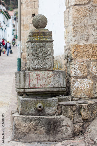 Stone fountain in which you can read the date of the founding of Mongui photo