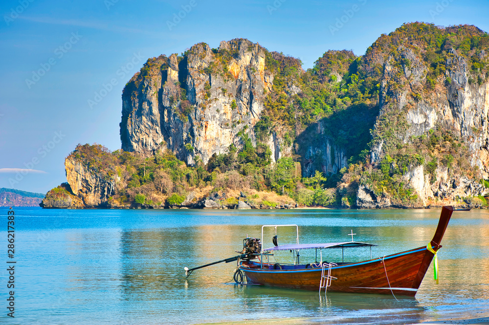 Sea view with long tail boat and mountain at Riley Beach, Krabi Province, Thailand