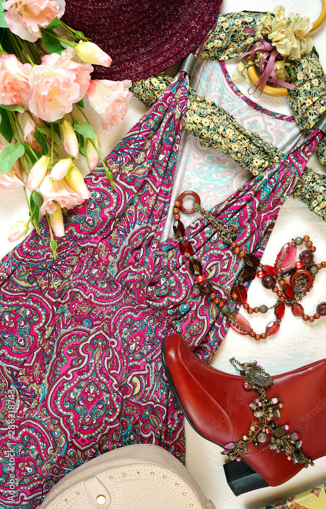 On-trend Boho Chic style fashion layout flat lay with red pink floral summer dress and accessories.