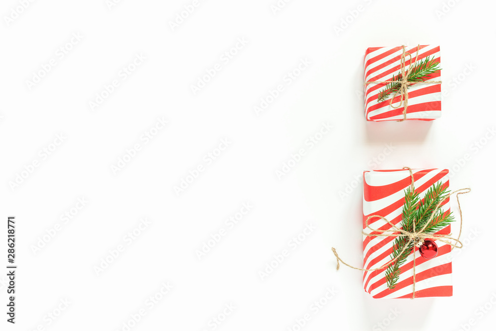 Obraz premium New Year Christmas holiday celebration gift box with decor on white background. Flat lay, top view, copy space. Minimal style