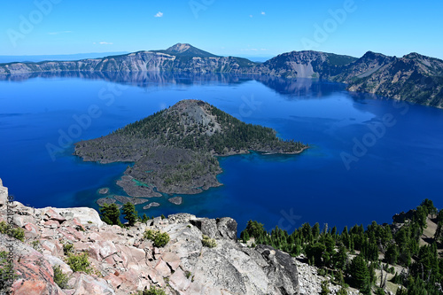 Crater Lake and Wizard Island in Crater Lake National Park , Oregon on a clear calm summer day.