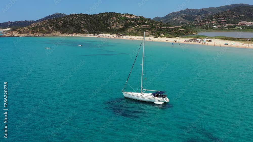 Yacht on lagoon at sunny day. Sailing boat. Yacht in the sea, aerial photography drone. Amazing yacht or sailing boat with a turquoise and transparent sea. Top view of the sailing boats in blue lagoon Yacht on lagoon at sunny day. Sailing boat. Yacht in the sea, aerial photography drone. Amazing yacht or sailing boat with a turquoise and transparent sea. Top view of the sailing boats in blue lagoon