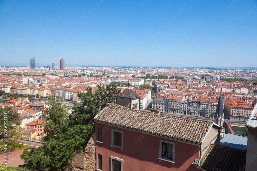 Aerial panoramic view of Lyon with the skyline of Lyon skyscrapers visible in background and Saone river in the foreground, with the narrow streets of Old Lyon district 