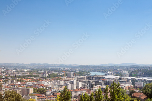 Fototapeta Naklejka Na Ścianę i Meble -  Aerial panoramic view of Lyon with the outskirts and suburbs of Lyon visible in background and Rhone river in the foregroud. Lyon is the second biggest city of France