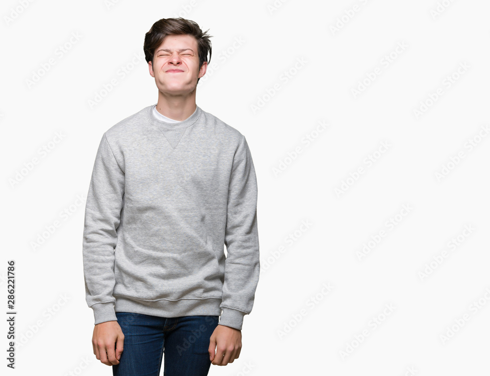 Young handsome sporty man wearing sweatshirt over isolated background puffing cheeks with funny face. Mouth inflated with air, crazy expression. Young handsome sporty man wearing sweatshirt over isolated background puffing cheeks with funny face. Mouth inflated with air, crazy expression.