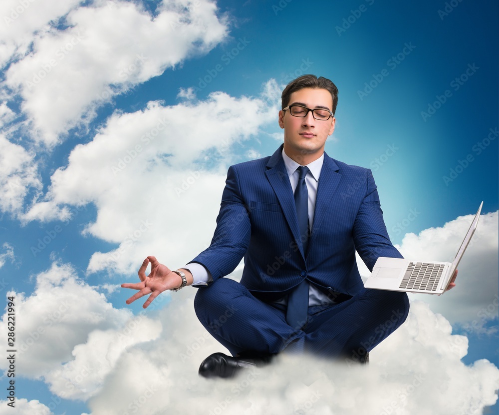 Businessman working on laptop in the sky Businessman working on laptop in the sky