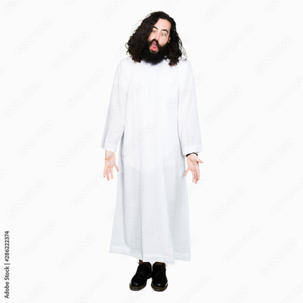 Man wearing Jesus Christ costume making fish face with lips, crazy and comical gesture. Funny expression. Man wearing Jesus Christ costume making fish face with lips, crazy and comical gesture. Funny expression.