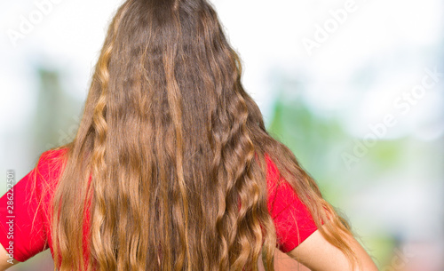 Young beautiful woman wearing casual t-shirt standing backwards looking away with arms on body © Krakenimages.com