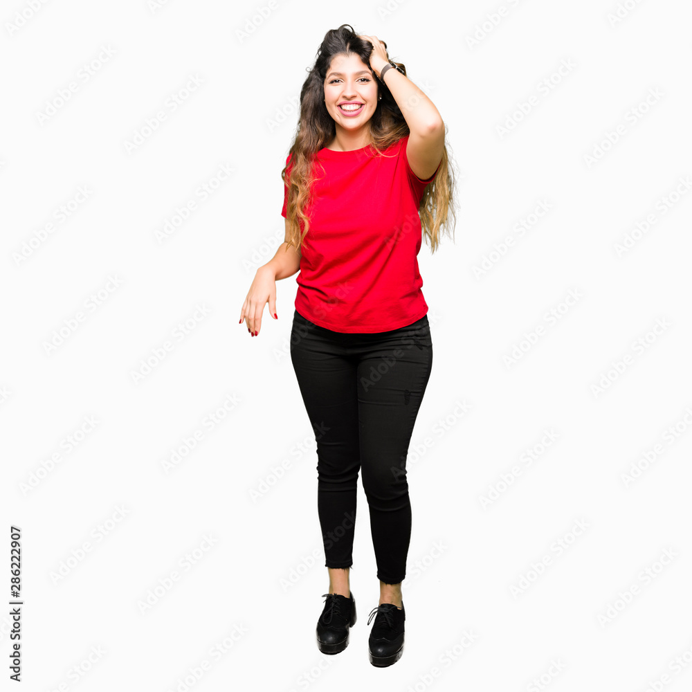 Young beautiful woman wearing casual t-shirt Smiling confident touching hair with hand up gesture, posing attractive Young beautiful woman wearing casual t-shirt Smiling confident touching hair with hand up gesture, posing attractive