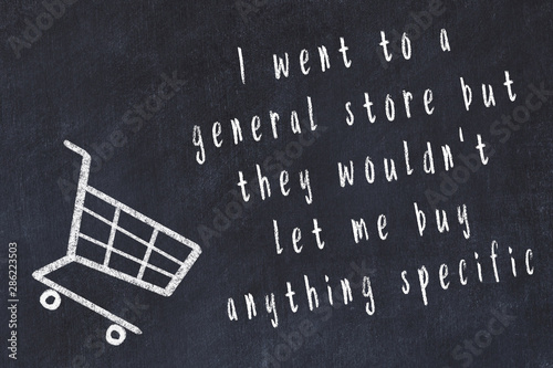 Chalk drawing of shopping cart and short quote about shopping on black board photo