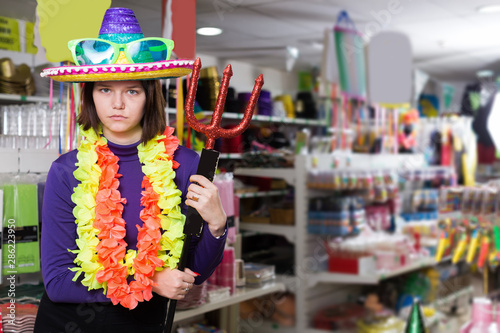 Young female standing in festival outfits at holiday store