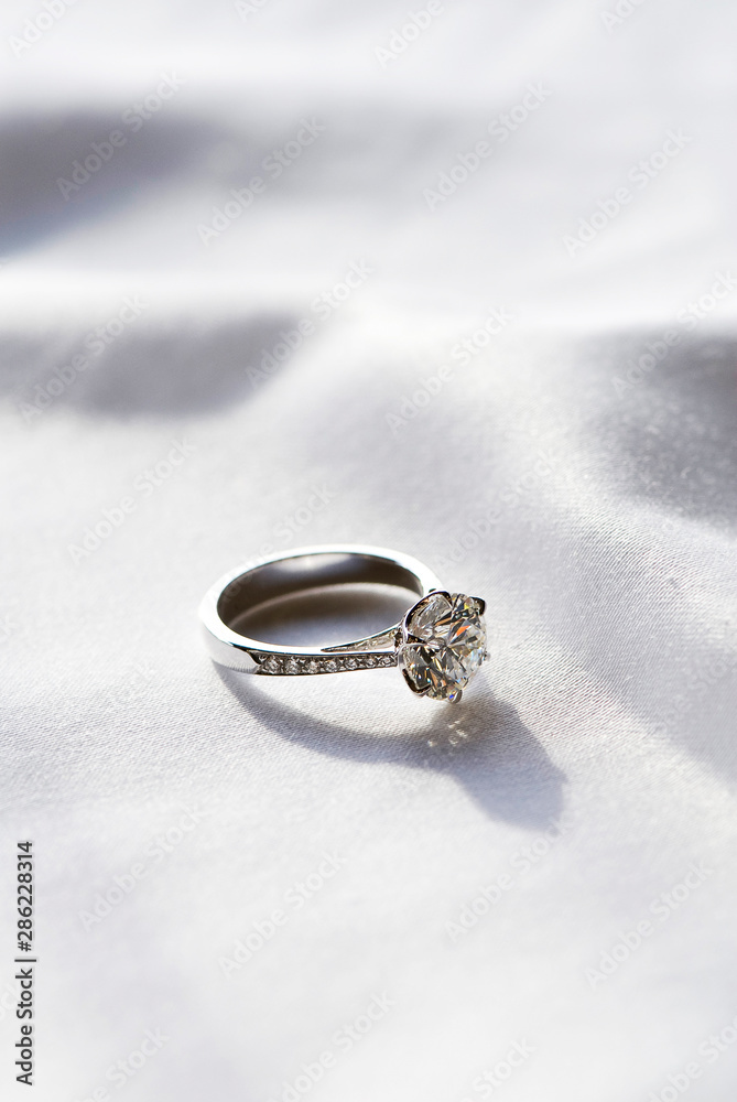 Wedding ring on fabric background