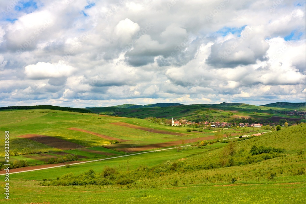 landscape with a village between hills in Romania
