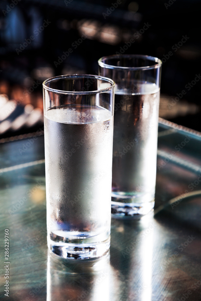 Cold fresh drinking water in glass on table Cold fresh drinking water in glass on table