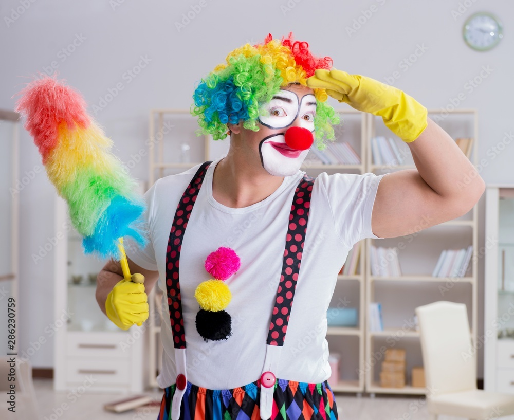 Funny clown doing cleaning at home Funny clown doing cleaning at home