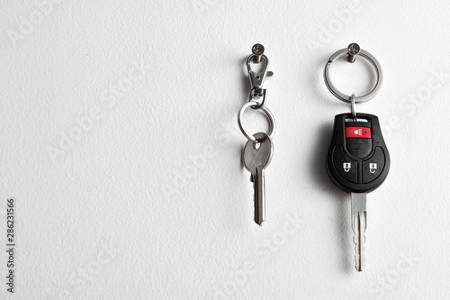 Car and house keys hanging on wall photo