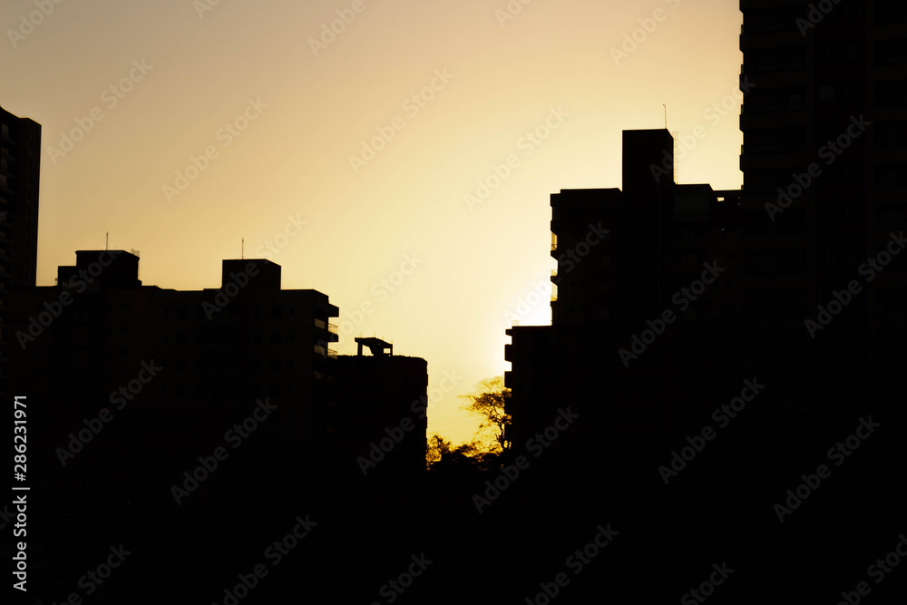 Sun setting behind buildings in Ribeirão Preto Sun setting behind buildings in Ribeirão Preto