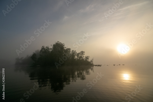 Fototapeta Naklejka Na Ścianę i Meble -  small island on a lake in mist, sympathy message 