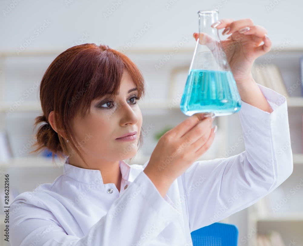 Female scientist researcher conducting an experiment in a labora Female scientist researcher conducting an experiment in a labora