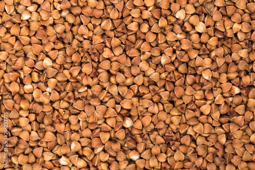 Macro Photo food buckwheat groats. Texture background grain buckwheat groats. Image food product porridge buckwheat grains