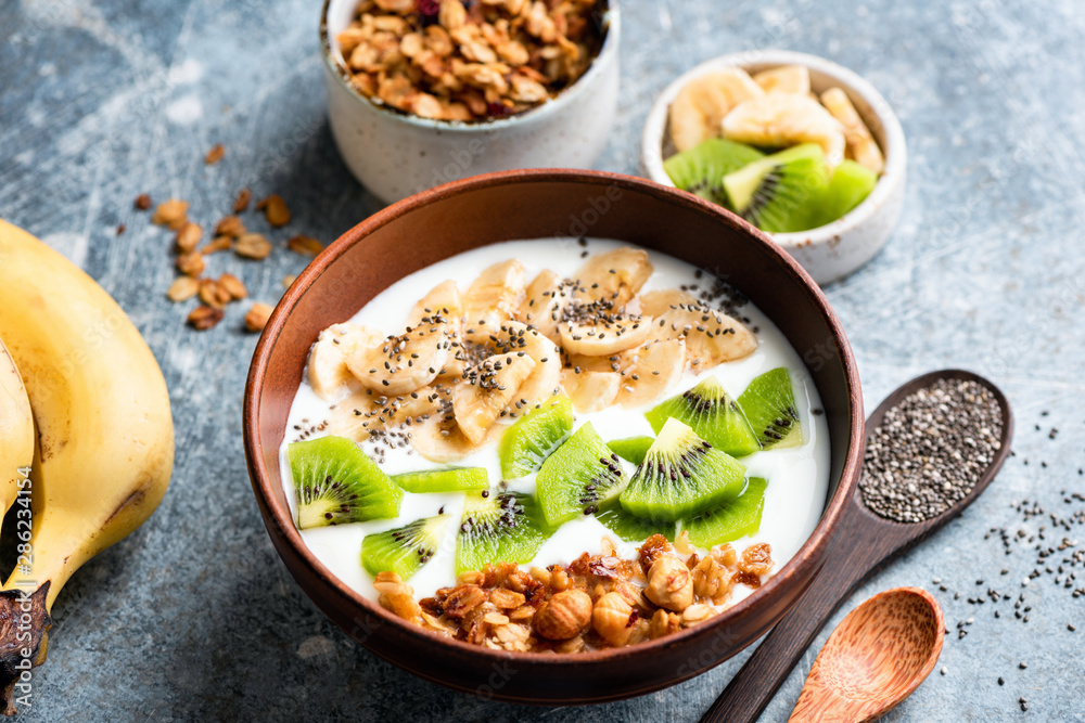 Fruit granola yogurt bowl with chia seeds. Healthy eating, dieting, weight loss concept