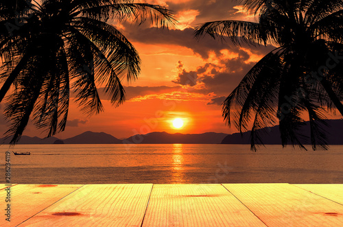 wooden table and sea at sunset summer background © thekopmylife