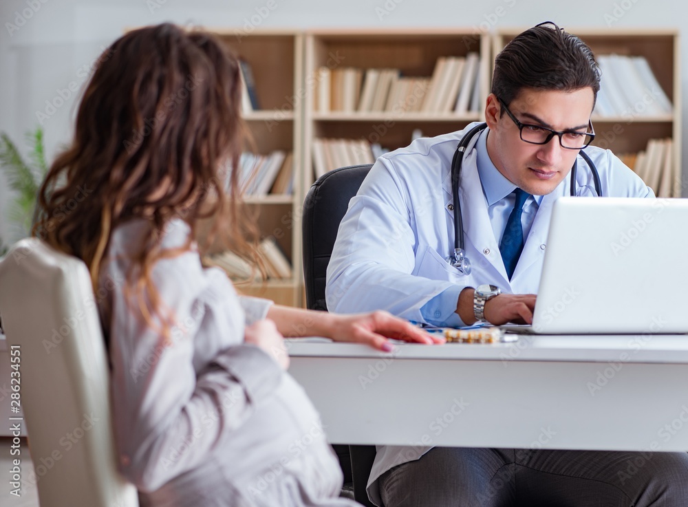 Fototapeta premium Pregnant woman visiting doctor for consultation