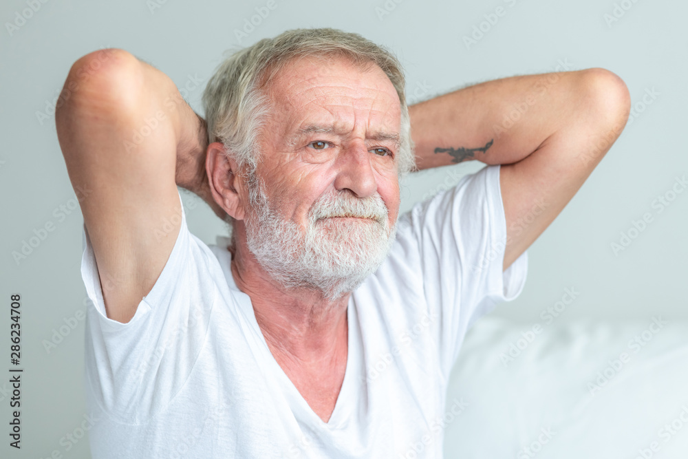 Obraz premium Senior man sitting in bed, cannot remember his name.