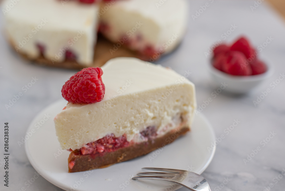Cheesecake slice with raspberries on a plate Cheesecake slice with raspberries on a plate