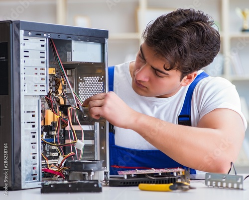 Wallpaper Mural Computer repairman repairing desktop computer Torontodigital.ca