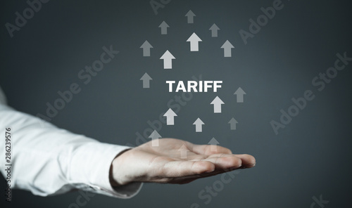 Man holding Tariff word with arrows.