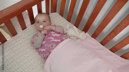 Wallpaper Mural A slow motion moving shot of little baby girl in crib with a soother Torontodigital.ca