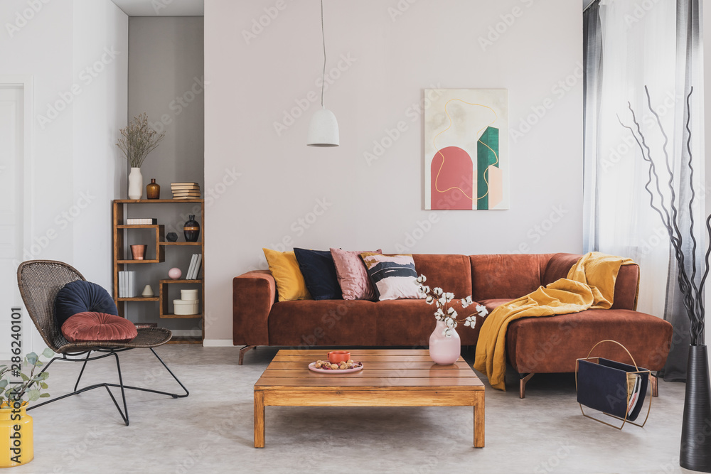 Flowers in vase on wooden coffee table in fashionable living room ...