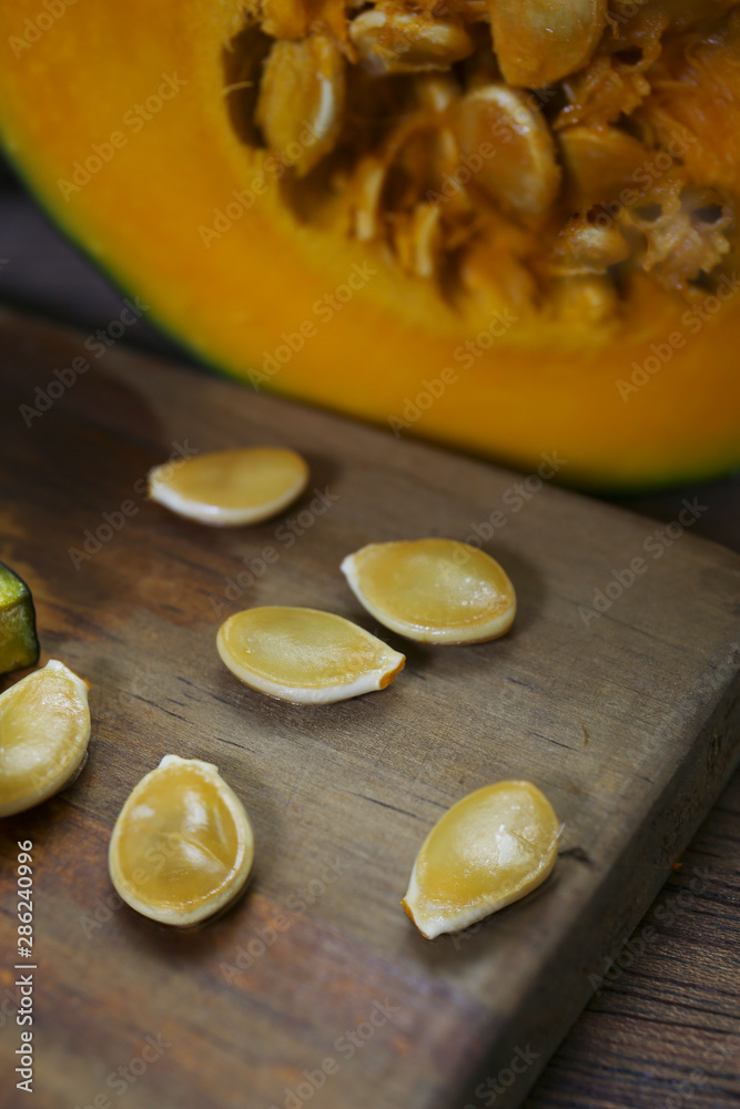sliced pumpkin and seeds on a wooden table sliced pumpkin and seeds on a wooden table