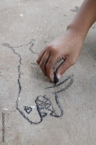 kid drawing with charcoal