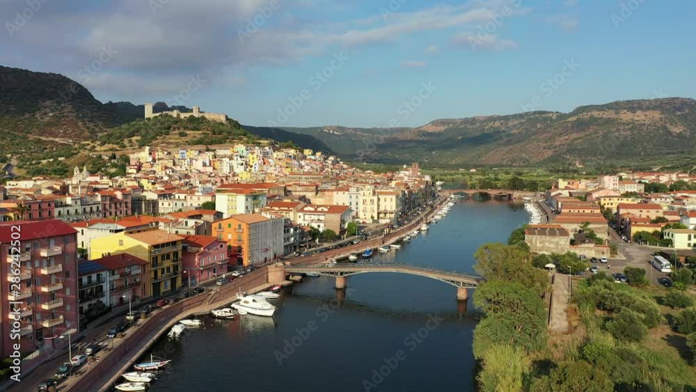 Aerial view of the beautiful village of Bosa with colored houses and a medieval castle. Bosa is located in the north-wesh of Sardinia, Italy. Aerial view of colorful houses in Bosa village, Sardegna. Aerial view of the beautiful village of Bosa with colored houses and a medieval castle. Bosa is located in the north-wesh of Sardinia, Italy. Aerial view of colorful houses in Bosa village, Sardegna.
