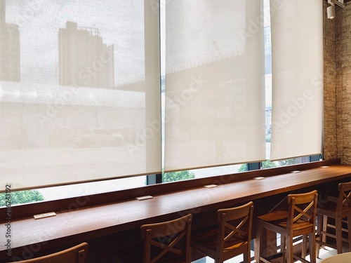 Modern blinds traditional home decoration. Sunlight coming through blinds by the window. Curtain at a window overlooking the highest Building of downtown outside.