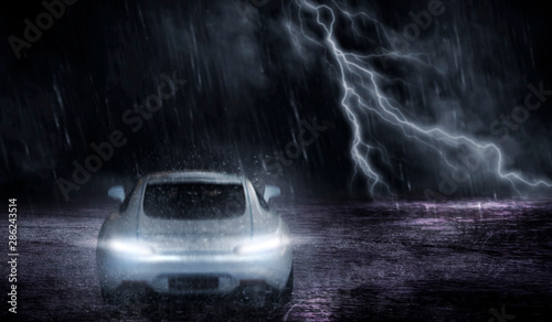 3D rendering the white sports car that focuses on the back, runs on a road with rain and lightning at night, motion blur concept. photo